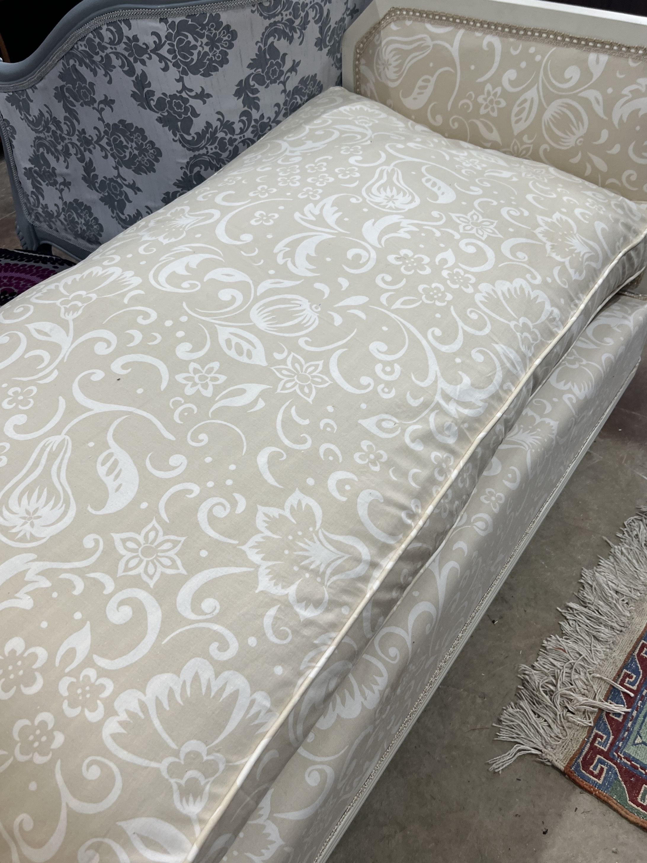 A French cream painted upholstered folding day bed, length 135cm, depth 68cm, height 77cm